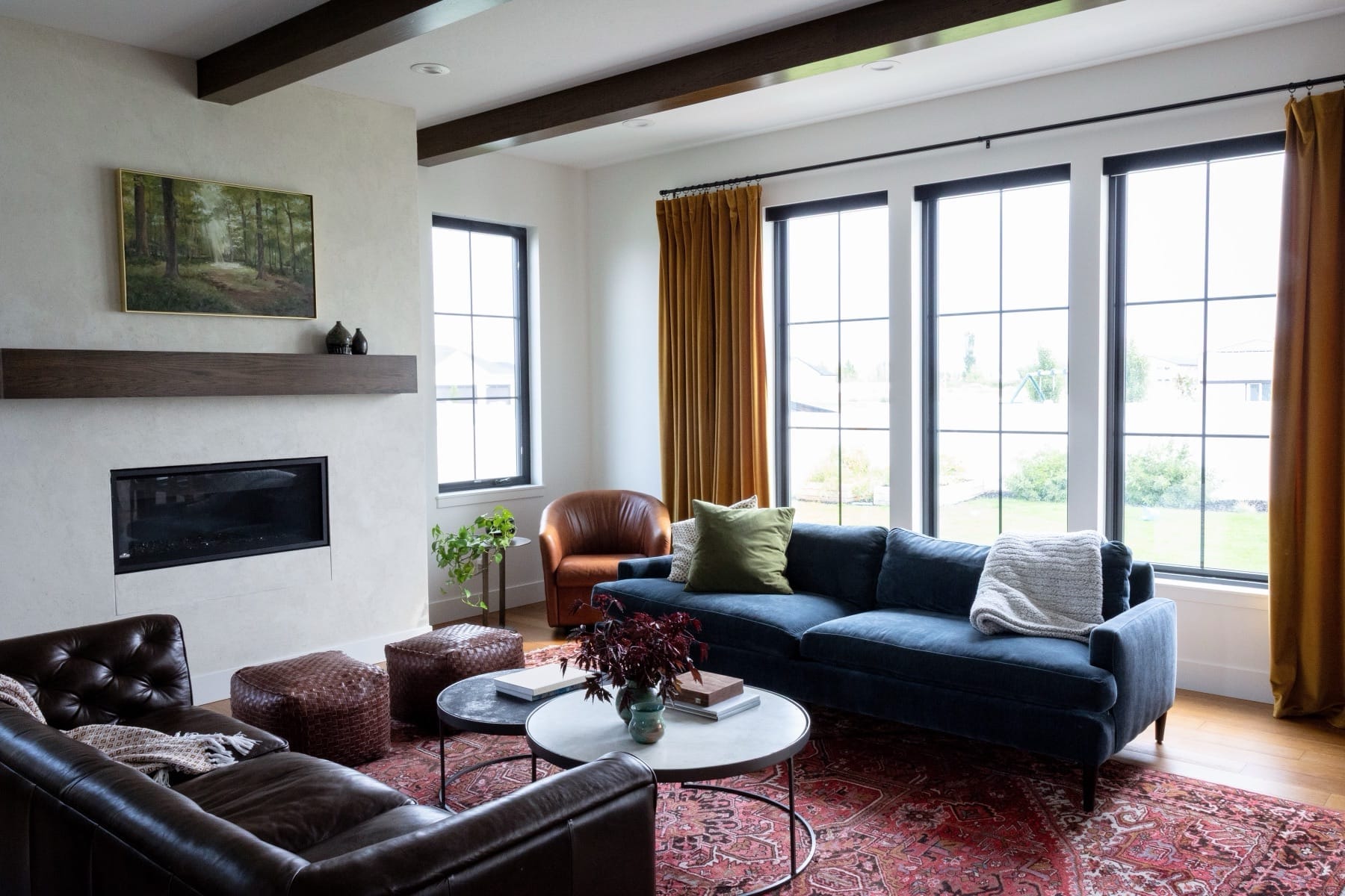 Living room seating area with a leather sofa and a blue sofa