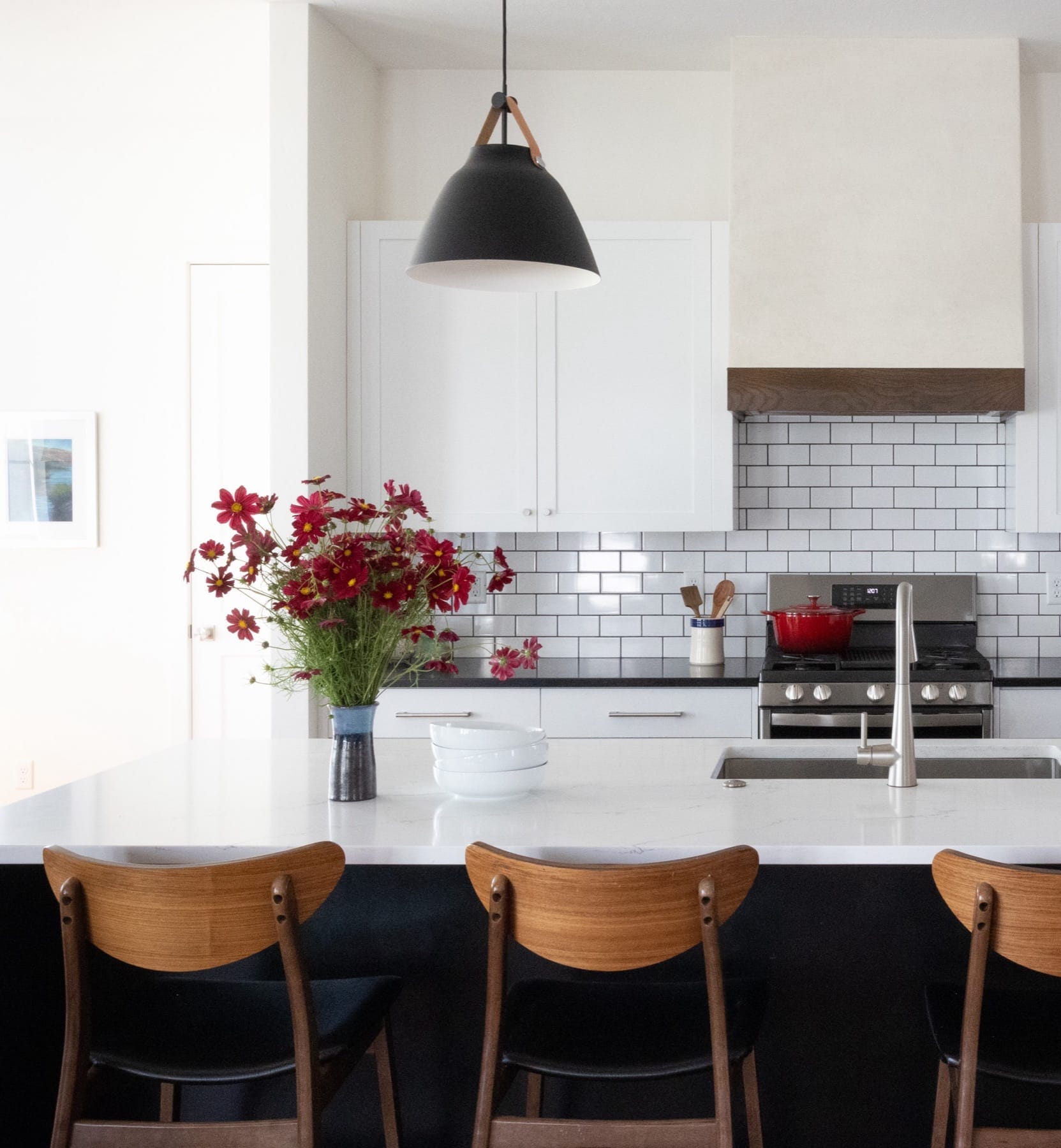 Kitchen island with counter stools and fresh flowers