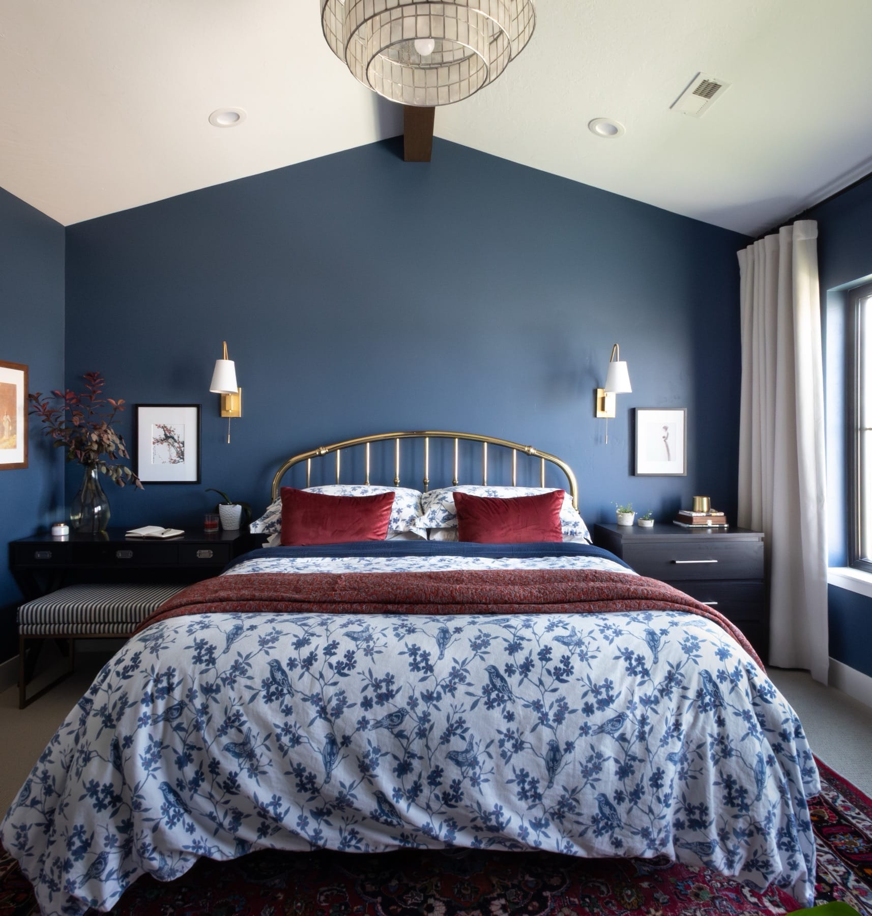 Primary bedroom with a vaulted ceiling and brass bed