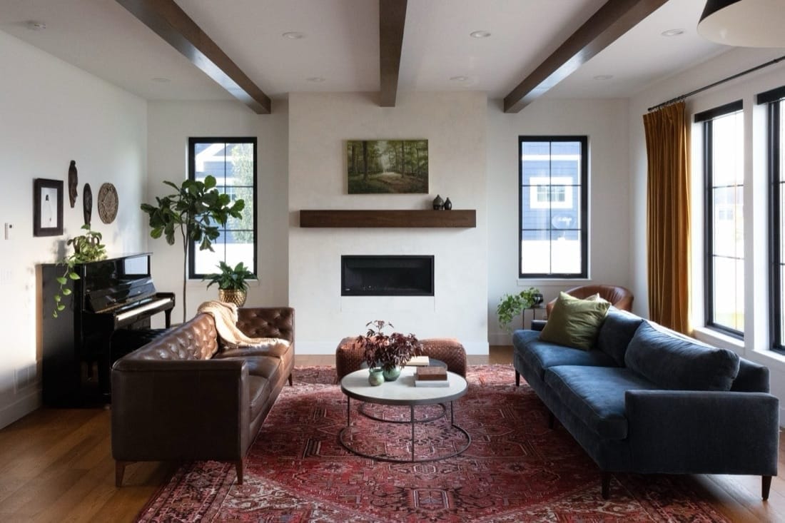 Brookside Residence: living room with a beamed ceiling, fireplace and red rug