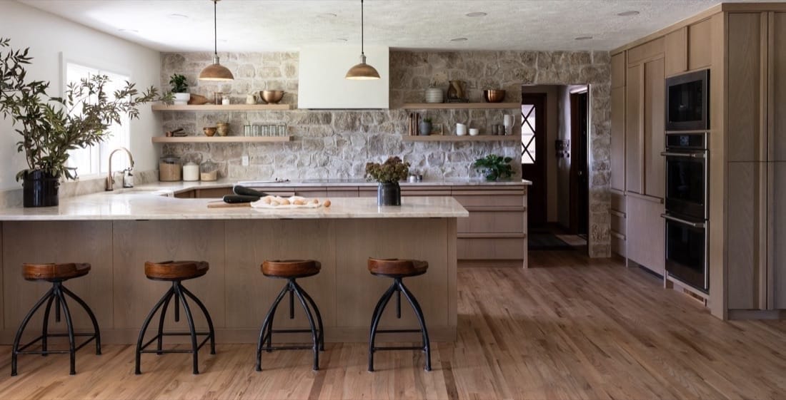 Farmhouse Kitchen: wood island with industrial stools and a stone backsplash
