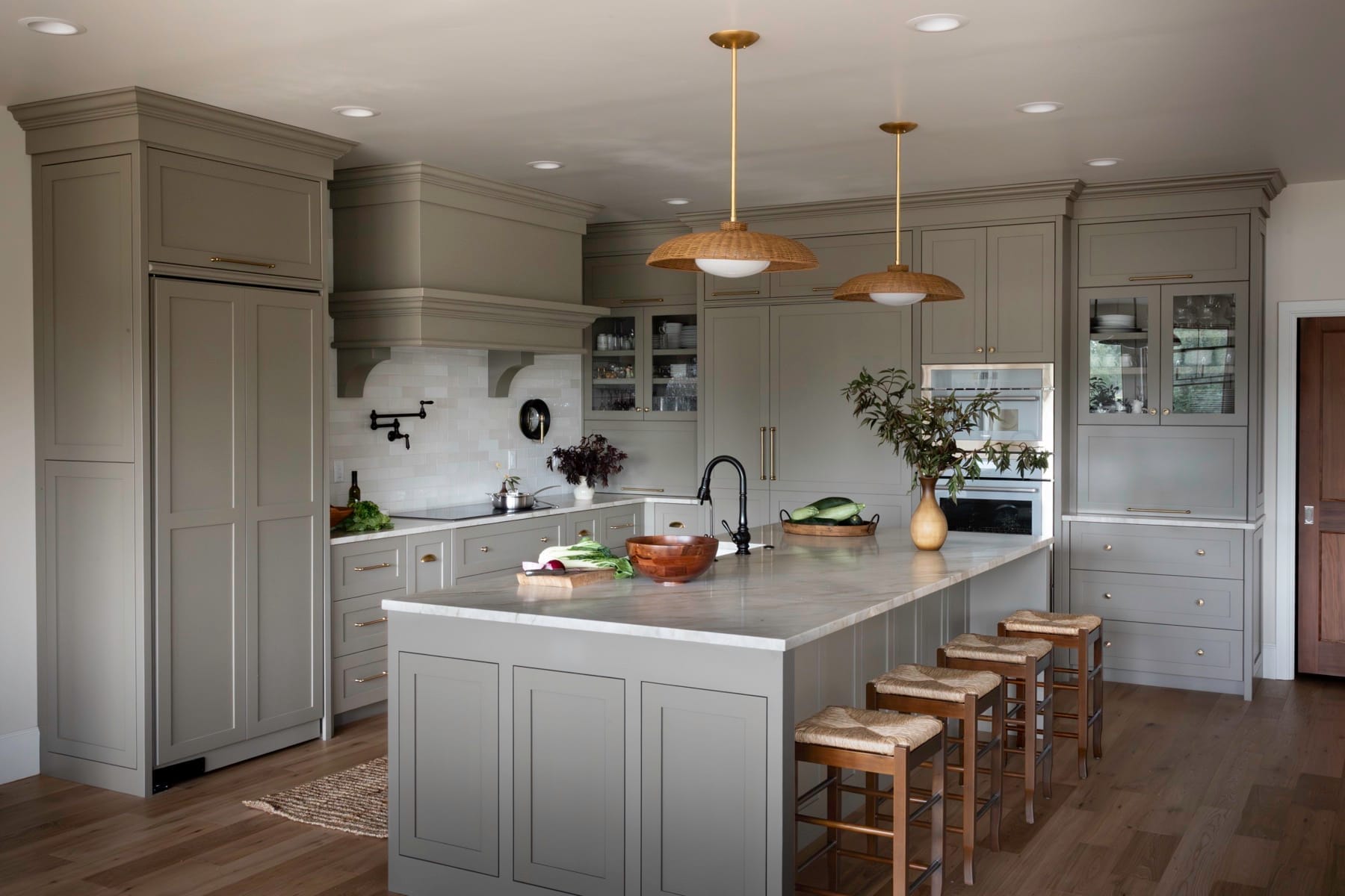 Creekside Heritage Home kitchen with gray cabinetry, a large island and rattan pendant lights
