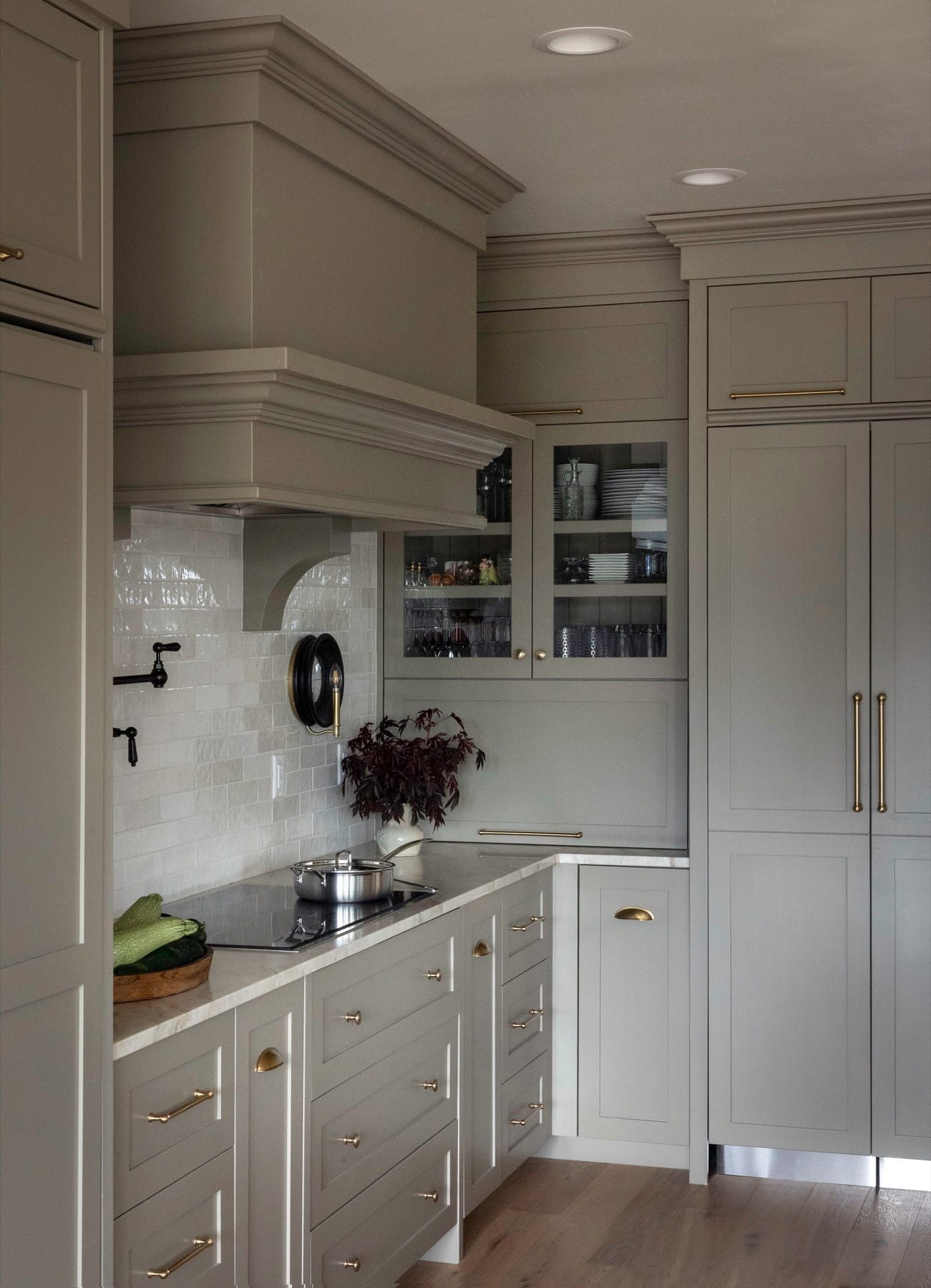 Glass-front kitchen cabinets and a marble countertop