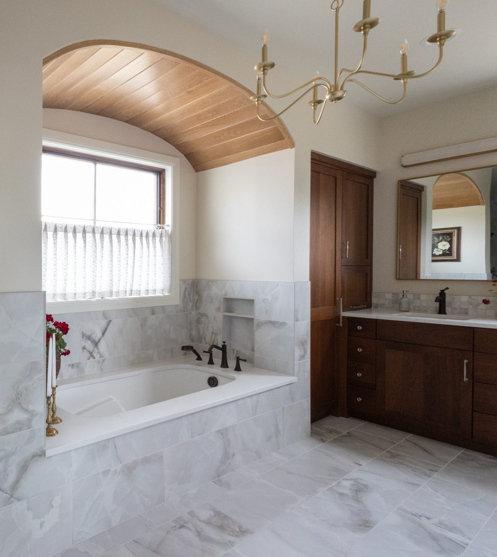 Soaking tub under an arched wood ceiling in the primary bathroom