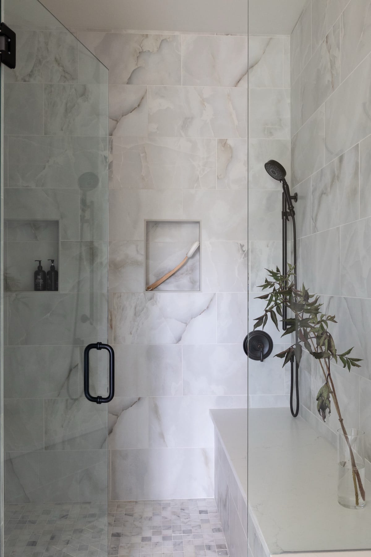 Marble shower niche with black hardware
