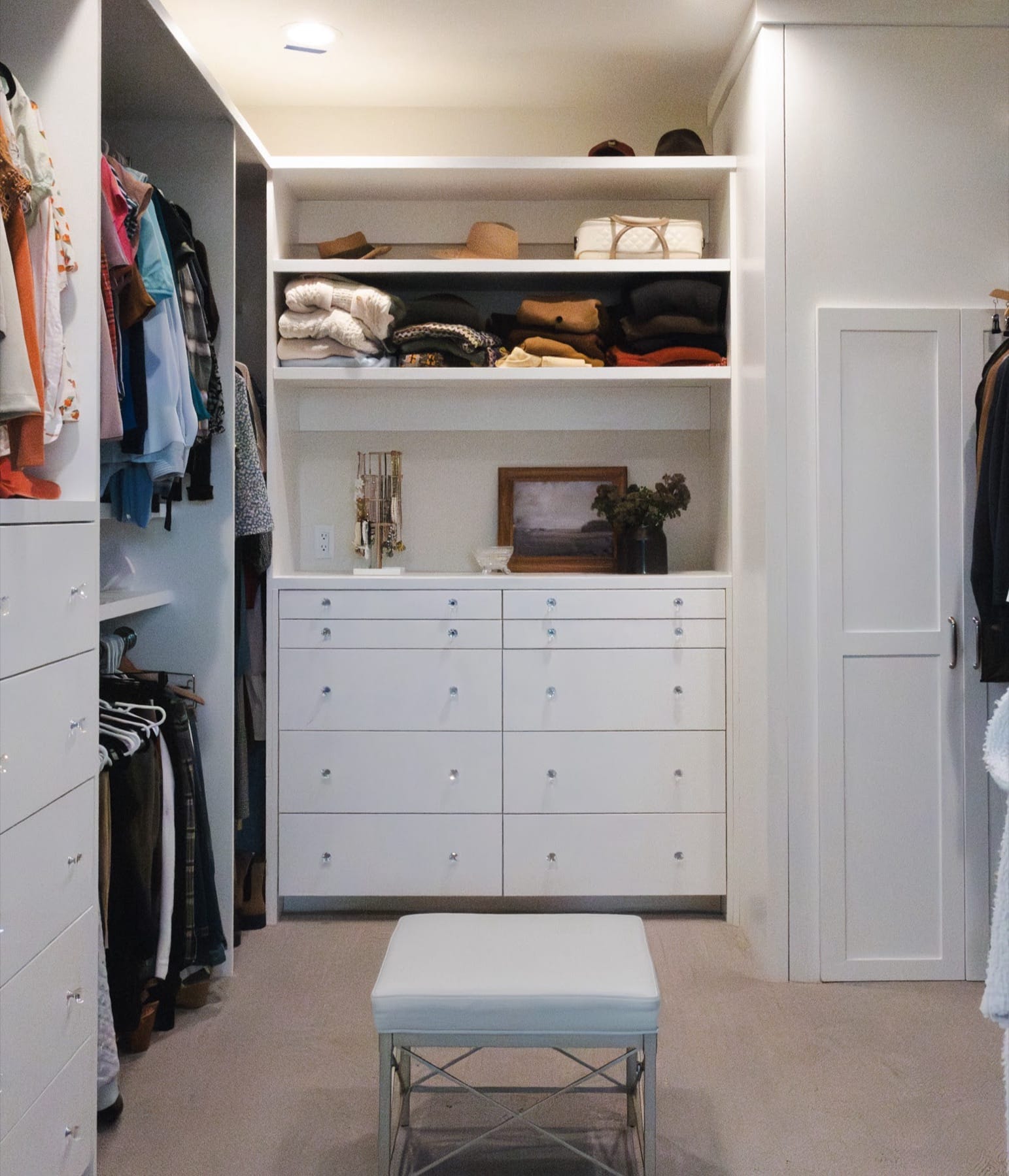 Walk-in closet with built-in shelving and drawers