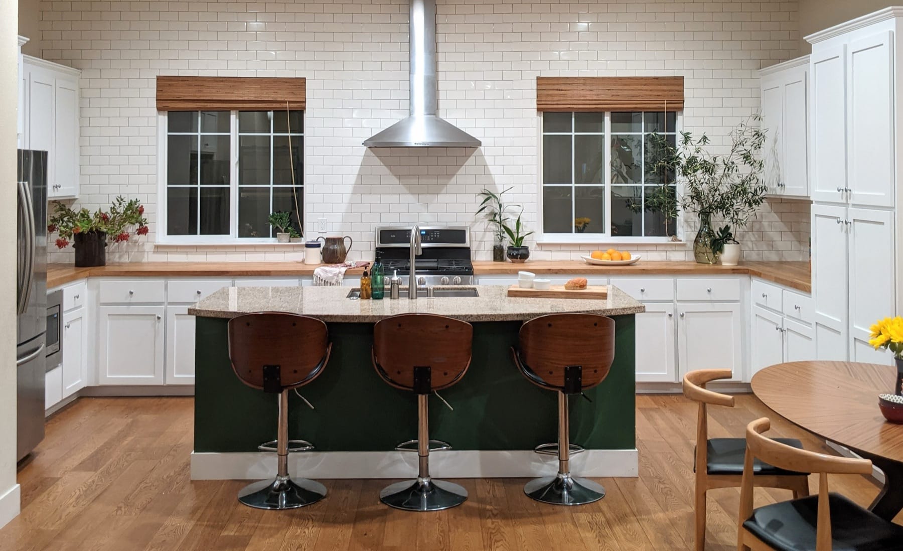 Sunnyvale Townhouse kitchen with a green island, butcher-block counters and subway tile